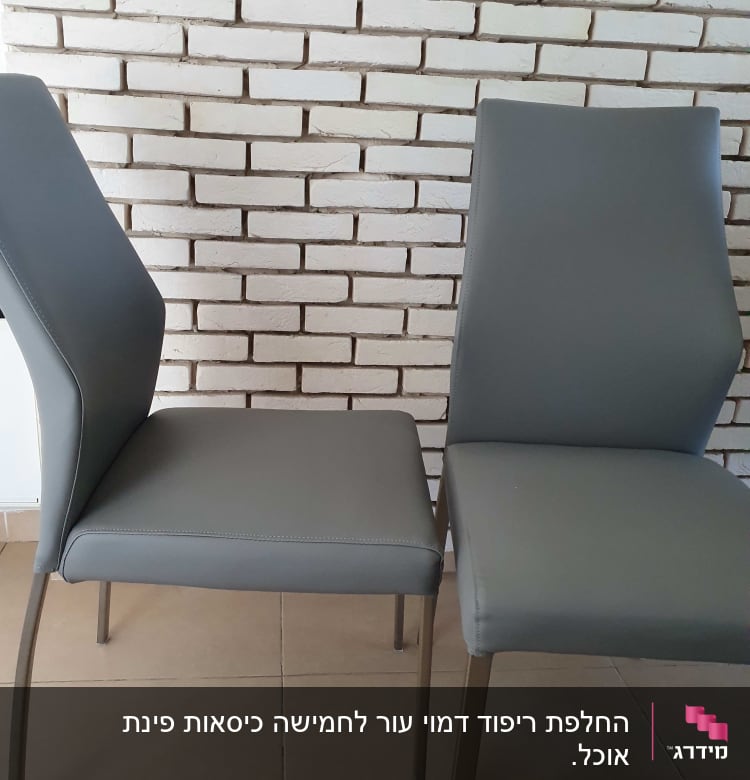 שני כיסאות מרופדים באפור על רקע קיר לבנים